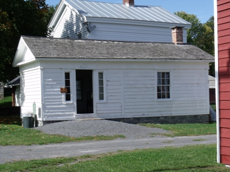 Law Office, one room white building.
