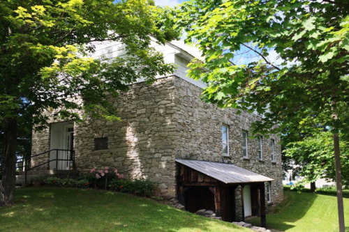 Badgely Annex, three story building made of stone and wood.