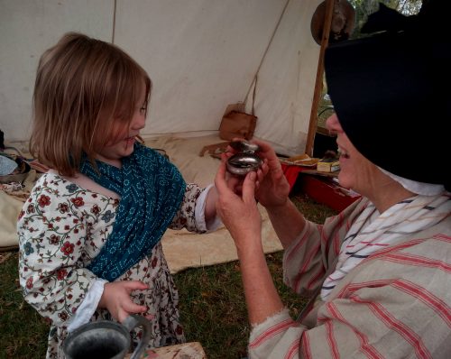 Woman and little girl in historical attire.