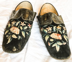 Pair of black slippers with flower design