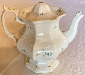 White teapot with flower pattern.