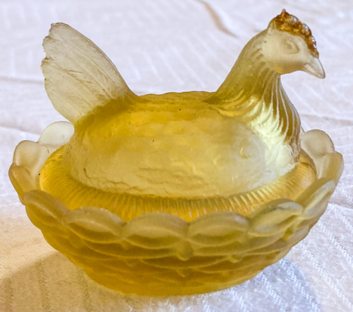 Yellow salt cellar with chicken cover.