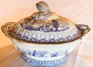 Blue and white tureen with flower and house pattern.