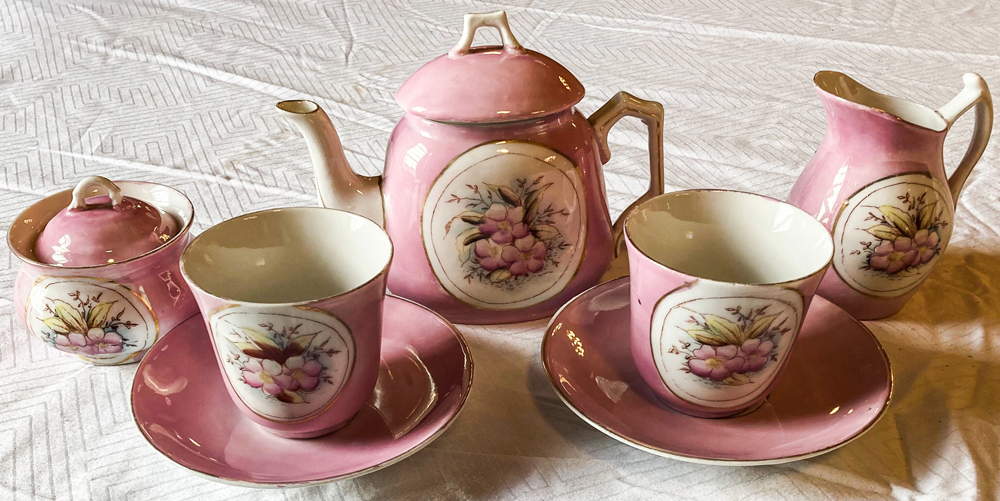 Pink tea set with flower paintings