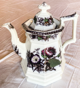 White tea pot with flower pattern.