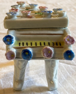 Decorative ceramic piano box front.