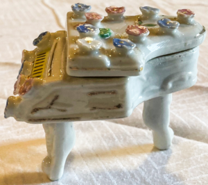 Decorative ceramic piano box side.