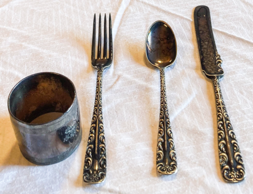 Silverware, cup, fork, spoon and butter knife.