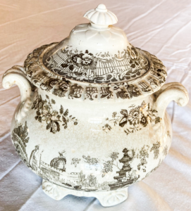 White tureen with flower, and landscape pattern.