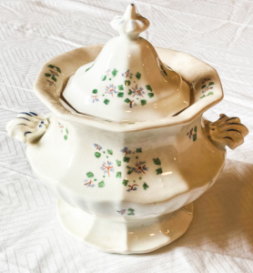 White tureen with small flower patterns.