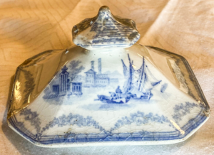 Tureen cover with houses and ships.