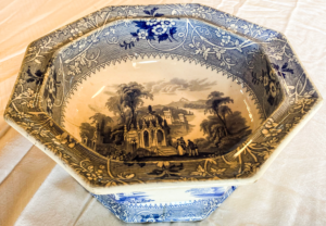 Tureen with blue and white flowers and house illustration.