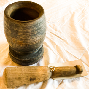 Mortar with pestle next to it.