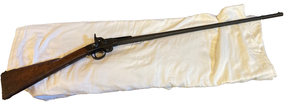 Carbine Rifle on white blanket.