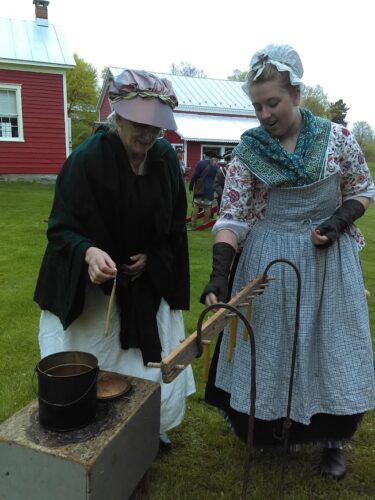 Two women in Colonial attire.