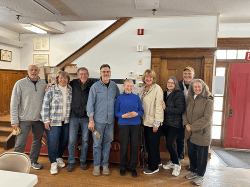 Nine people pose for a photo