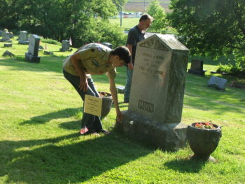 Boy scout laying flower