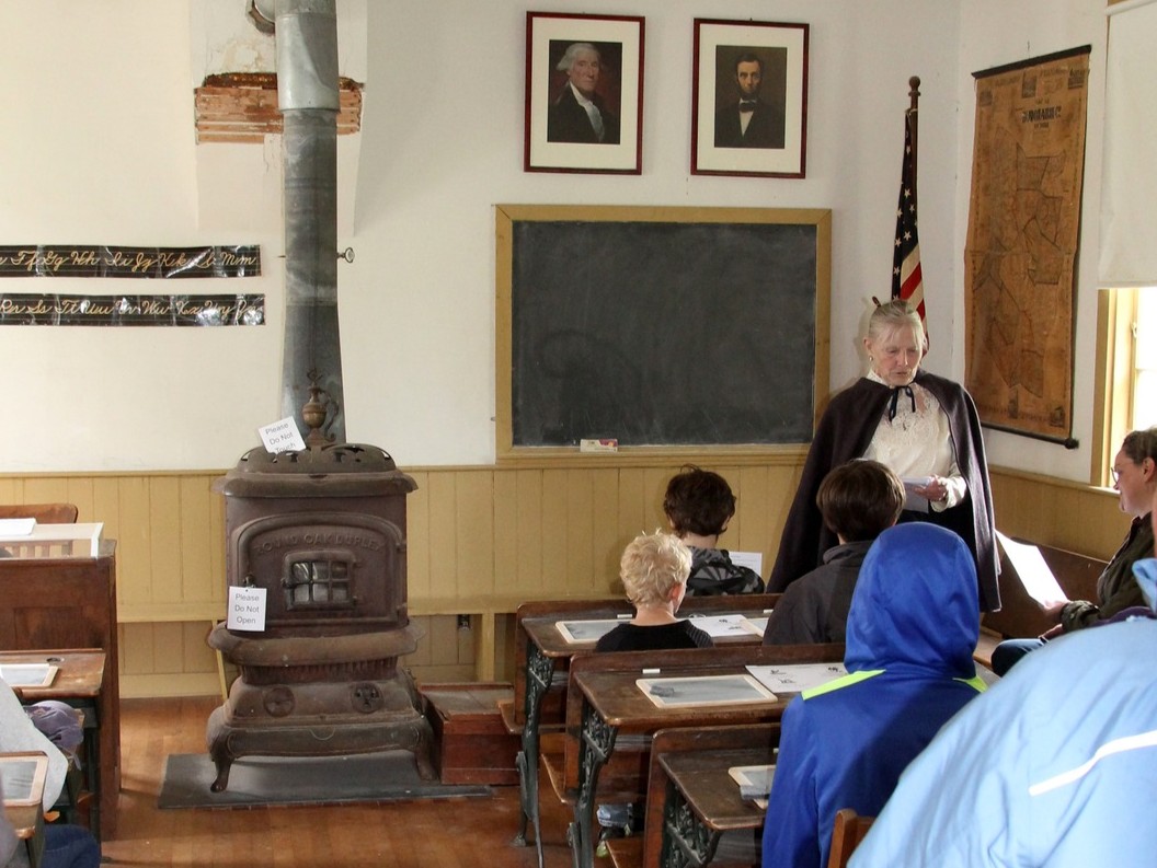 Schoolmarm teaching in the schoolhouse.