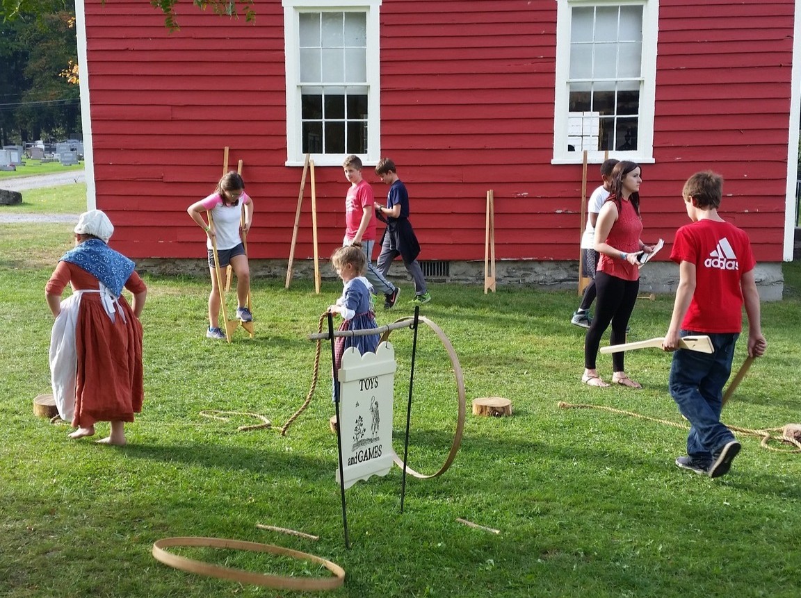 Kids playing with 18th century toys