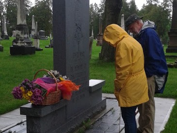 Two people looking at Civil War Monument outside in the rain.