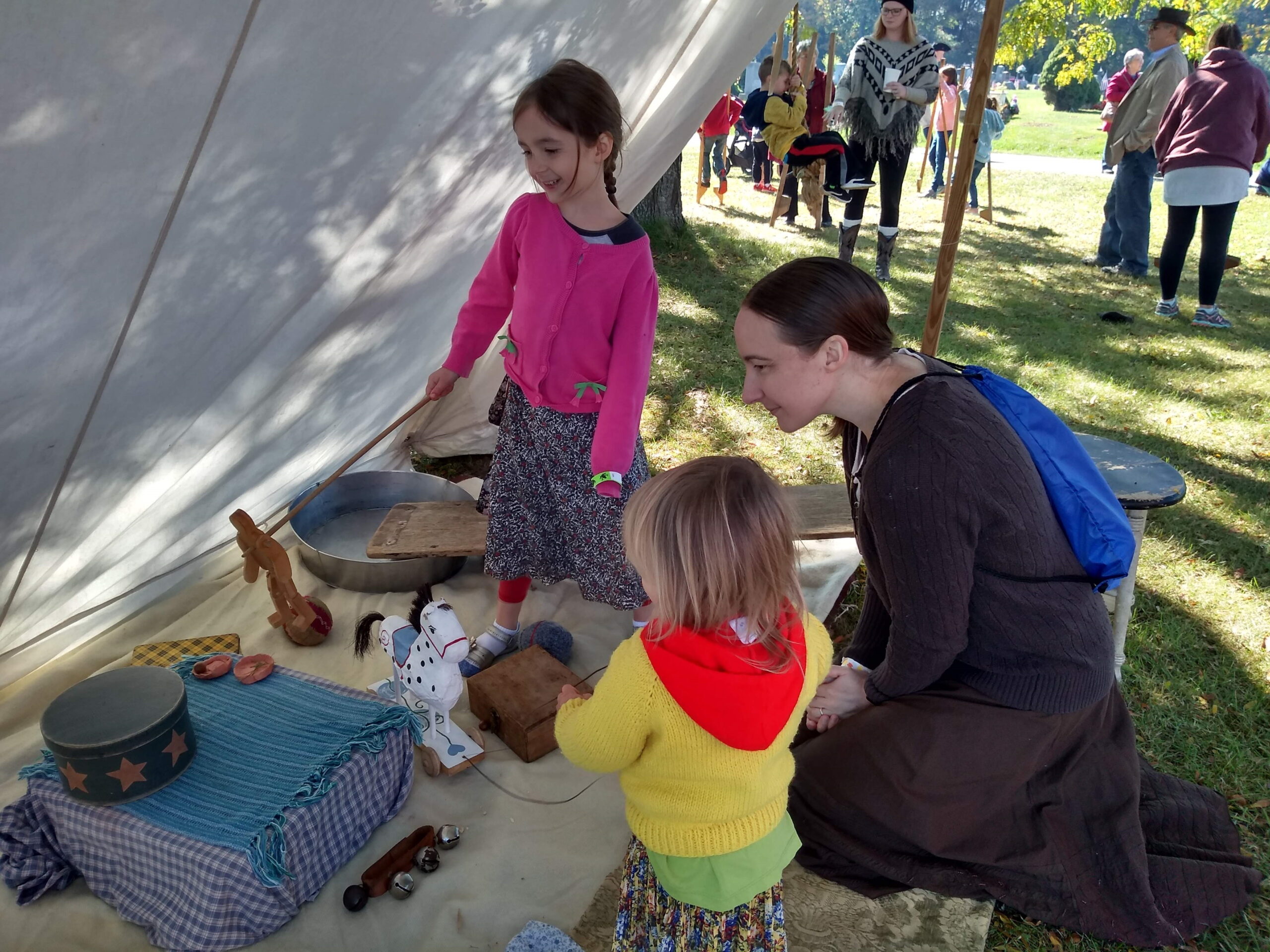 A mother with her two kids looking at artifacts.