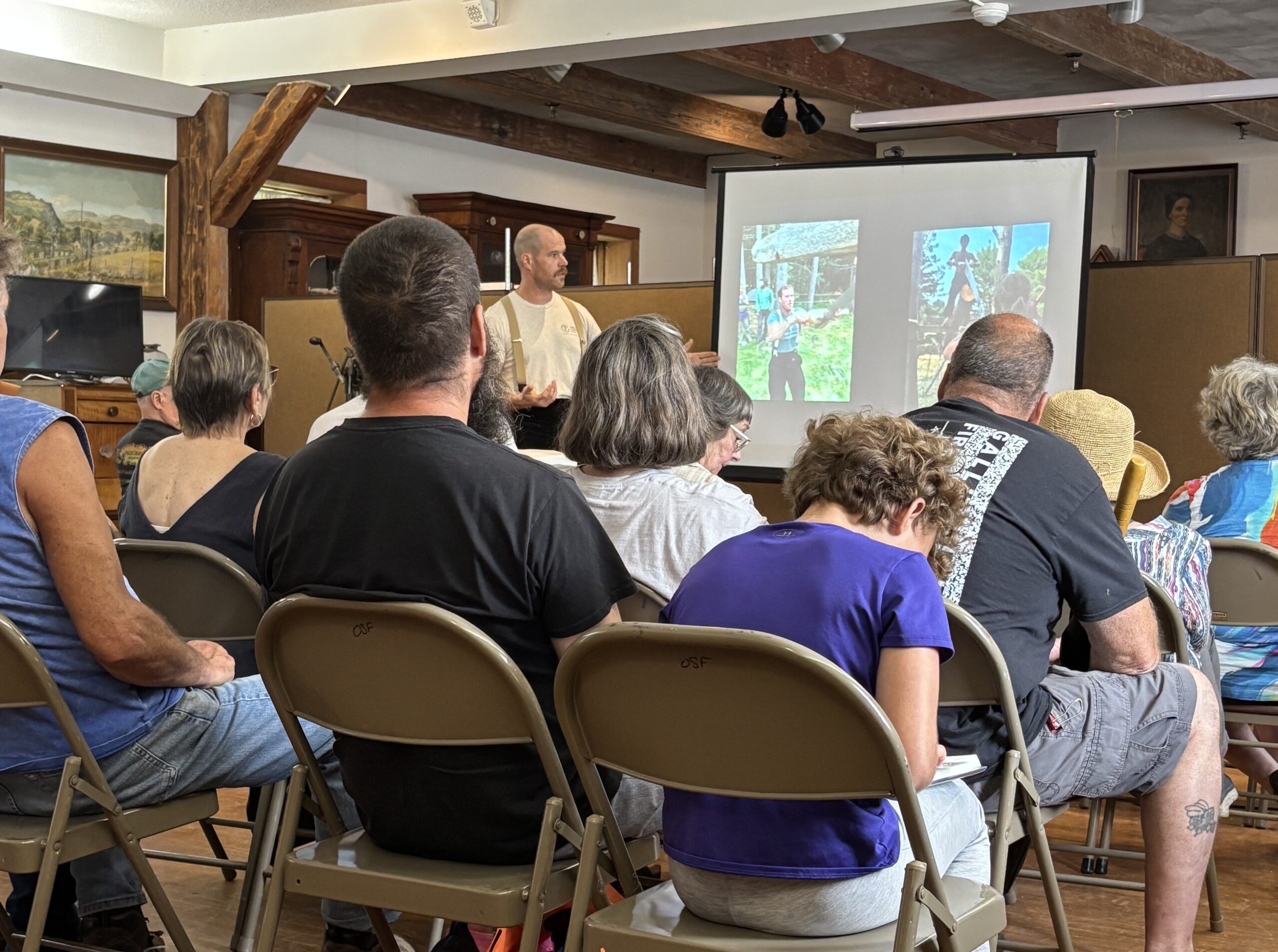 Audience watching presentation on timber framing.