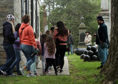 Tour guide showing a group around the Fort.