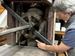 Conservator showing off the inner mechanics of the Deluge fire engine.