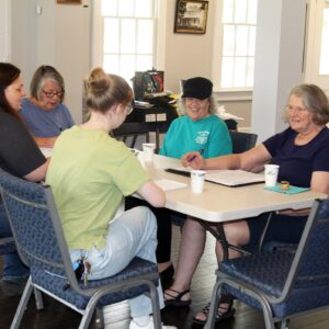Group around table at a fundraising meeting.