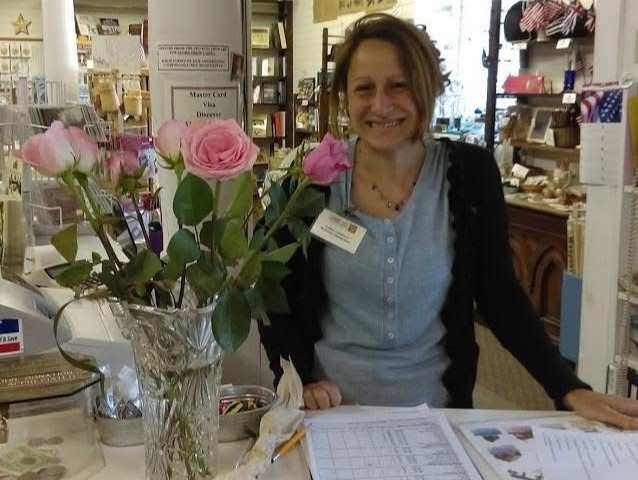 Museum docent working at the admissions desk.