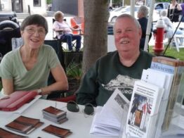 Two volunteers tabling at information table.