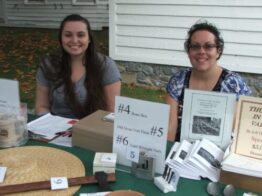 Two volunteers tabling at raffle table.