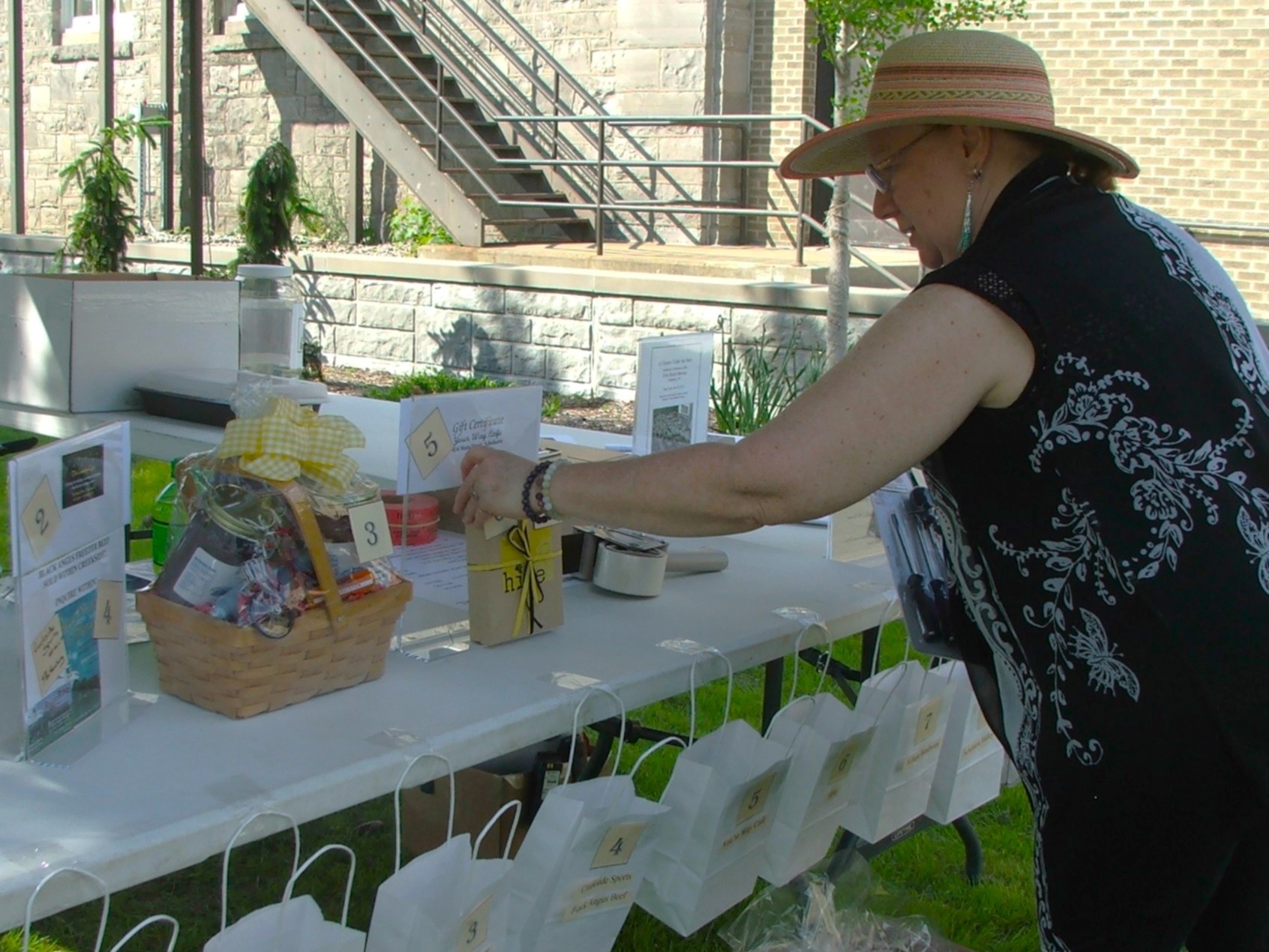 Volunteer setting up a raffle table.