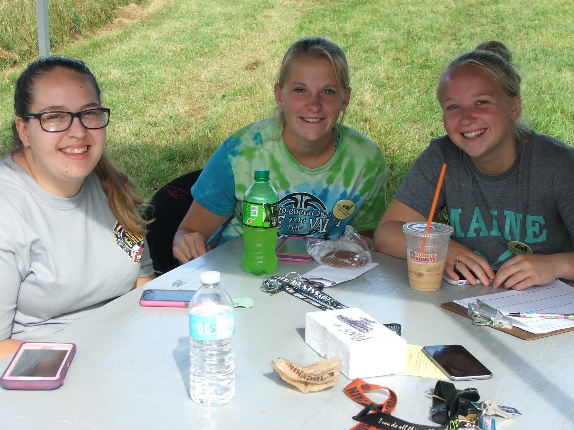 Three teens tabling.