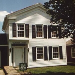 Classic Greek Revival style house, painted white.