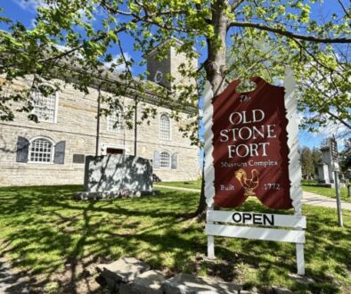Open sign in front of the Old Stone Fort.