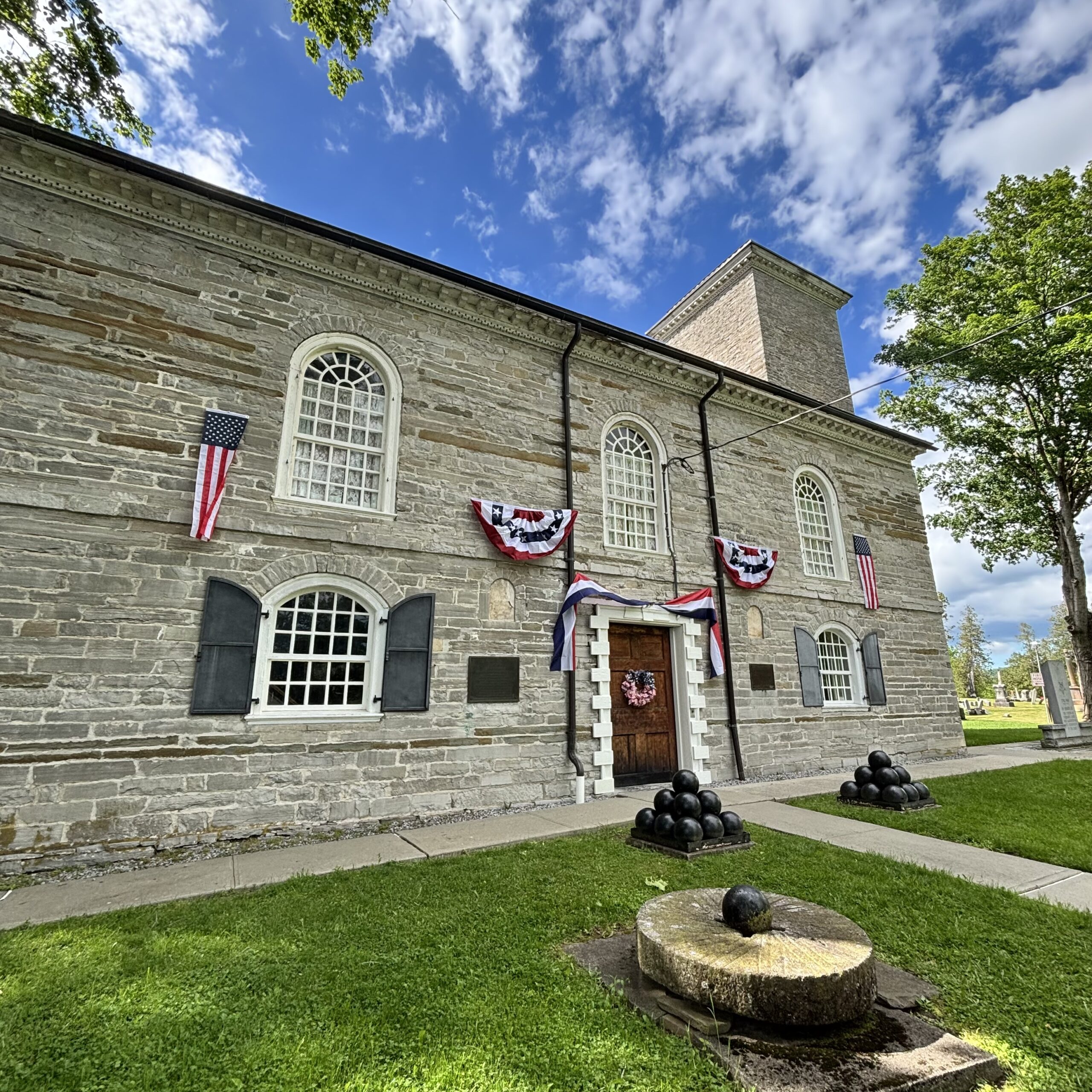 The Old Stone Fort decorated in red white and blue bunting for America's Semiquincentennial